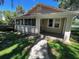 Quaint home featuring a screened-in porch and a welcoming entrance at 1010 S Grove St, Eustis, FL 32726