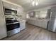 Bright kitchen featuring gray cabinets, stainless steel appliances, and tile backsplash at 1010 S Grove St, Eustis, FL 32726