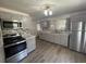 Gray kitchen with stainless steel appliances and wood-look floors at 1010 S Grove St, Eustis, FL 32726