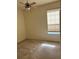 Well-lit bedroom with neutral carpeting and a ceiling fan at 1332 Hunterman Lane, Winter Garden, FL 34787