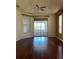 Bright bedroom featuring wood floors and sliding doors to a sunroom at 1332 Hunterman Lane, Winter Garden, FL 34787