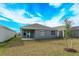 Home exterior view with grassy backyard at 5807 Wallis Ln, Saint Cloud, FL 34771