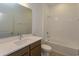 Clean bathroom with tub, vanity, and white tile at 5807 Wallis Ln, Saint Cloud, FL 34771