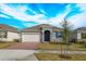 One-story home with gray siding, brick pavers, and a two-car garage at 5807 Wallis Ln, Saint Cloud, FL 34771