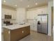 Modern kitchen with white cabinets, stainless steel appliances and an island at 5807 Wallis Ln, Saint Cloud, FL 34771