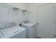 Laundry room with washer, dryer and shelving at 5807 Wallis Ln, Saint Cloud, FL 34771