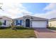 Two-story home boasts gray siding, blue shutters, and a brick paver driveway at 5820 Springer St, Saint Cloud, FL 34771