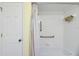This bathroom has grab bars and a shower-tub combo with white tile at 17548 Se 96Th Ave, Summerfield, FL 34491
