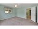 Bedroom with soft neutral carpet, a ceiling fan, and a large, bright window at 17548 Se 96Th Ave, Summerfield, FL 34491