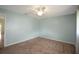 The primary bedroom is spacious with a standard closet and carpet at 17548 Se 96Th Ave, Summerfield, FL 34491