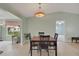 Open dining room with a decorative Tiffany-style chandelier and view to living room at 17548 Se 96Th Ave, Summerfield, FL 34491