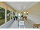Enclosed patio with a table and seating for outdoor dining at 17548 Se 96Th Ave, Summerfield, FL 34491