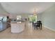 Bright kitchen with stainless appliances, island and adjacent dining area at 17548 Se 96Th Ave, Summerfield, FL 34491