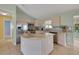 Bright kitchen with stainless steel appliances, granite countertops, and ample cabinet space at 17548 Se 96Th Ave, Summerfield, FL 34491