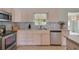 Close-up of the kitchen featuring stainless steel appliances, granite countertops, and mosaic backsplash at 17548 Se 96Th Ave, Summerfield, FL 34491