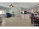 Open-concept living room showcases tile flooring, a ceiling fan, and flows seamlessly into the kitchen area at 17548 Se 96Th Ave, Summerfield, FL 34491