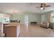 Bright and airy living room featuring tile floors, ceiling fan, and neutral decor at 17548 Se 96Th Ave, Summerfield, FL 34491