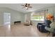 Comfortable living room featuring neutral paint, a ceiling fan and a bright window at 17548 Se 96Th Ave, Summerfield, FL 34491