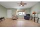 Comfortable living room with tile floors, featuring two cozy chairs and a ceiling fan for added comfort at 17548 Se 96Th Ave, Summerfield, FL 34491