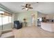 Living room featuring tile flooring, natural light, and an open transition into the kitchen area at 17548 Se 96Th Ave, Summerfield, FL 34491