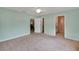 Spacious main bedroom with neutral carpet, ceiling fan and attached bathroom at 17548 Se 96Th Ave, Summerfield, FL 34491