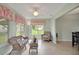 Relaxing sunroom with large windows and comfortable seating at 17548 Se 96Th Ave, Summerfield, FL 34491