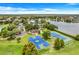 Aerial view of community amenities including a park, lake, playground, and tennis courts at 1103 White Water Bay Dr, Groveland, FL 34736
