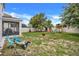 Large backyard with a fire pit, playground, shed, and a basketball hoop at 1103 White Water Bay Dr, Groveland, FL 34736