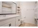 Well-lit bathroom featuring a vanity, a toilet, and a shower with neutral colors at 1103 White Water Bay Dr, Groveland, FL 34736