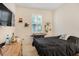 Neutral bedroom with a large window, dresser, and a dark-colored bedspread at 1103 White Water Bay Dr, Groveland, FL 34736