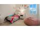 Bright bedroom with a cozy bed, a beanbag chair, and a window at 1103 White Water Bay Dr, Groveland, FL 34736
