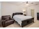 Bedroom with a ceiling fan, dark wood furniture, and carpeted floors at 1103 White Water Bay Dr, Groveland, FL 34736