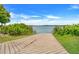 Scenic boat ramp leading to a calm lake, surrounded by lush greenery and a clear blue sky at 1103 White Water Bay Dr, Groveland, FL 34736