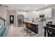 Modern kitchen with white cabinets, stainless steel appliances, a center island, and bar stool seating at 1103 White Water Bay Dr, Groveland, FL 34736