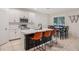 Well-lit kitchen boasts an island with seating and a dining area near a window at 1103 White Water Bay Dr, Groveland, FL 34736