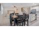 Open-concept living area with tile flooring, a dark wood dining table, and an adjacent kitchen at 1103 White Water Bay Dr, Groveland, FL 34736
