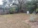 Spacious backyard with wooden fence, landscaping, and mature trees offers privacy and tranquil retreat at 14700 Se 94Th Ave, Summerfield, FL 34491