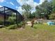Spacious backyard featuring a pool, deck, and lush landscaping, perfect for outdoor enjoyment and relaxation at 14700 Se 94Th Ave, Summerfield, FL 34491