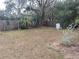 Large backyard with mature trees and a wooden fence at 14700 Se 94Th Ave, Summerfield, FL 34491