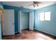 Light blue bedroom with tile flooring, double door closet, and ceiling fan at 14700 Se 94Th Ave, Summerfield, FL 34491