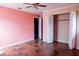 Bedroom with light pink walls and ample closet space at 14700 Se 94Th Ave, Summerfield, FL 34491