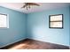 Light blue bedroom with a window and tiled floors at 14700 Se 94Th Ave, Summerfield, FL 34491