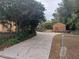Long driveway leading to a charming home with fenced yard and mature trees, offering privacy and curb appeal at 14700 Se 94Th Ave, Summerfield, FL 34491