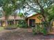 Charming one-story home featuring a stone accent wall, mature landscaping, and a screened front porch at 14700 Se 94Th Ave, Summerfield, FL 34491