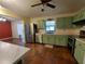 Kitchen with stainless steel appliances and light green cabinets at 14700 Se 94Th Ave, Summerfield, FL 34491