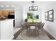 Dining area with modern chandelier, dining table and chairs, and backyard view at 14853 Sw 26Th Ln, Ocala, FL 34481