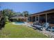 Backyard pool with stone decking and lawn at 213 Stevenage Dr, Longwood, FL 32779