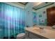 Bathroom with a single sink vanity, large mirror, and shower with a fun ocean-themed curtain at 213 Stevenage Dr, Longwood, FL 32779