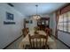 Formal dining room featuring a chandelier, large table, and a window with wood blinds at 213 Stevenage Dr, Longwood, FL 32779