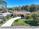 Charming home with a well-manicured lawn and a long driveway leading to the front entrance at 213 Stevenage Dr, Longwood, FL 32779
